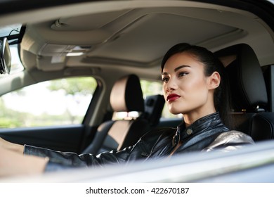 Stylish Woman In Leather Jacket Driving Car