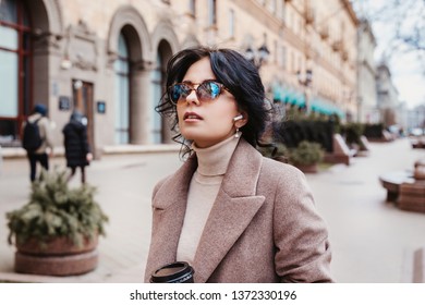 Stylish Woman Listning Music On Her Airpods In City