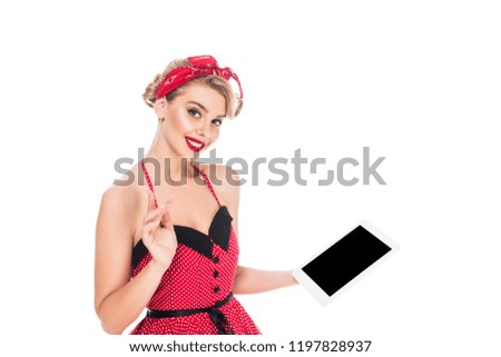 stylish woman in pin up clothing holding digital tablet with blank screen isolated on white