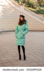 Stylish Woman Posing In Winter Autumn Fashion Trend Blue Puffer Coat And Hat Beret In Old Beautiful Street Full Heigth