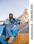 A stylish woman rides a classic scooter near the Victor Emmanuel II Monument in Rome, capturing the essence of freedom, travel, and urban elegance. Ideal for tourism, adventure, and lifestyle concepts