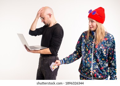 Stylish Woman Stealing Money From The Man Working At The Computer Over White Background