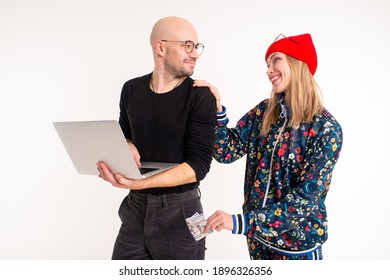 Stylish Woman Stealing Money From The Man Working At The Computer Over White Background