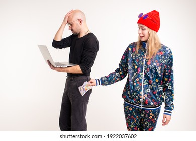 Stylish Woman Stealing Money From The Man Working At The Computer Over White Background