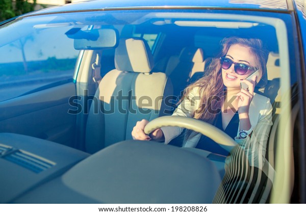  stylish woman talk phone\
in car