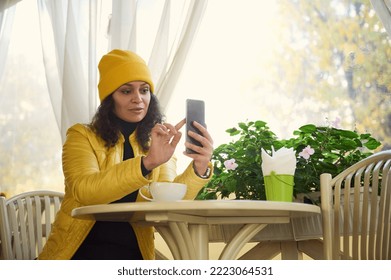 Stylish Woman Using Mobile Phone While A Coffee Break In A Cafe. Reading News, Social Network, Surfing The Internet, Scrolling Newsfeed, Checking Content In Social Media In Smartphone. Coffee Break