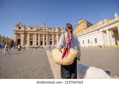 Stylish woman walks with a dog on the main square in Vatican. Concept of italian lifestyle and travel Italy - Shutterstock ID 2137567423