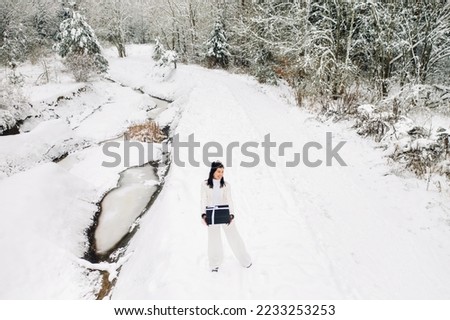 Similar – Image, Stock Photo Girl waiting at the side of the snowy mountain road looking down