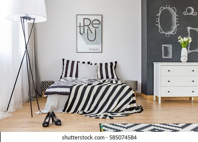 Stylish Woman's Bedroom With Big Bed And Chalkboard Wall