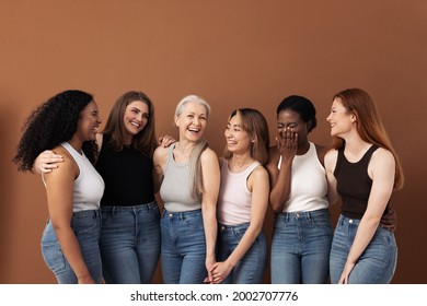 Stylish Women Of Different Ages Having Fun While Wearing Jeans And Undershirts Over Brown Background