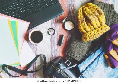 Stylish women's clothing, handbag, cosmetics and laptop. Light blue jeans, brown wool sweater, yellow hat and striped scarf. Autumn or winter outfit fashion blogger. Flat lay background, top view  - Powered by Shutterstock