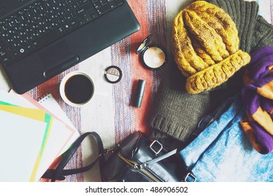 Stylish women's clothing, handbag, cosmetics and laptop. Light blue jeans, brown wool sweater, yellow hat and striped scarf. Autumn or winter outfit fashion blogger. Flat lay background, top view - Powered by Shutterstock