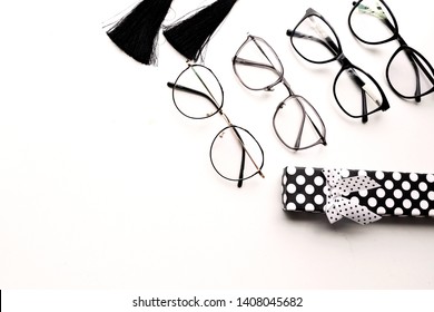 Stylish women's glasses on white background, optics store. Minimalism flat lay. Place for text.