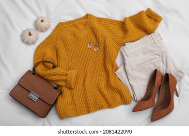 Stylish Women's Outfit On White Fabric, Flat Lay. Fall Fashion