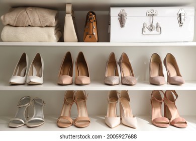 Stylish Women's Shoes, Clothes And Bags On Shelving Unit