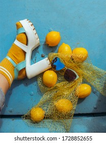 Stylish Women's Summer Shoes On A Blue Boat Background With Lemons And Glasses