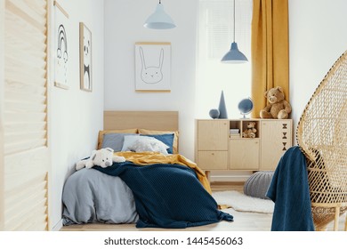 Stylish Wooden Commode In Bright Bedroom Interior With Poster On The Wall