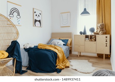 Stylish Wooden Commode In Bright Bedroom Interior With Poster On The Wall