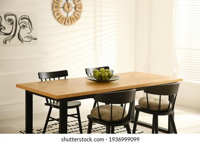 Stylish wooden dining table and chairs in room. Interior design - Shutterstock ID 1936999099