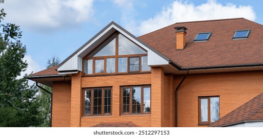 A stylish wooden residence features oversized windows, showcasing a contemporary design amidst a lush landscape under blue skies - Powered by Shutterstock