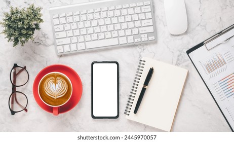 Stylish work desk setup with a keyboard, mouse, smartphone, coffee cup, glasses, and a notebook on a marble surface, ideal for business planning and productivity.