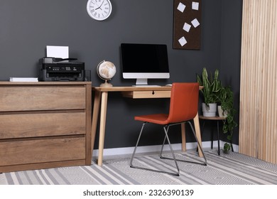 Stylish workplace with modern computer and printer at home