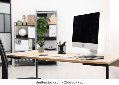 Stylish workplace with modern computer and stationery on wooden table in office