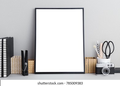 Stylish Workspace With Black Empty Photo Frame For A Poster, Stationery, Books And A Copy Space. Mock Up