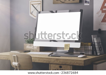 Stylish workspace with computer and posters on home or studio