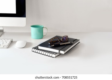 Stylish workspace with desktop computer, office supplies and books at home or studio. 