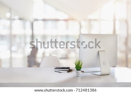 Stylish workspace with desktop computer, office supplies, houseplant and books at office. desk work concept.