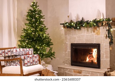 Stylish wrapped christmas gifts on arm chair against christmas tree with festive lights and cozy burning fireplace. Christmas eve, holiday time. Atmospheric living room with xmas presents - Powered by Shutterstock