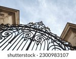 Stylish wrought iron gate and stone pillars