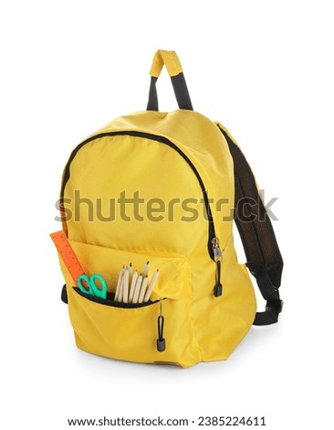 Stylish yellow school backpack with different stationery supplies on white background