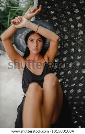 Brunette surfer woman with top and bikini holding surfboard