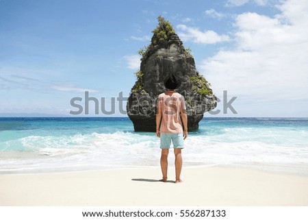 Feet standing on stone spiral staircase