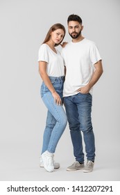 Stylish Young Couple In Jeans On White Background