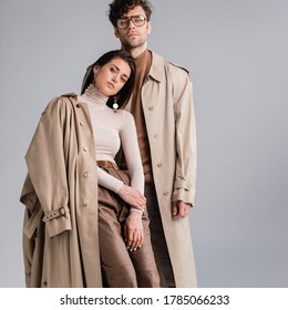 stylish young couple looking at camera while posing in autumn clothes isolated on grey - Shutterstock ID 1785066233