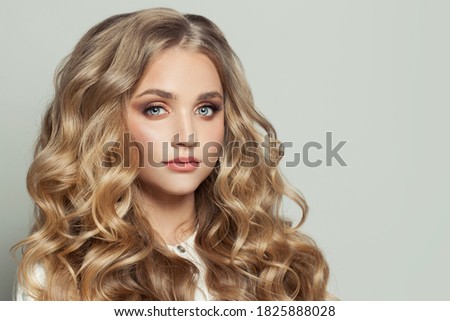 Stylish young fashion model woman with long healthy curly hairstyle 