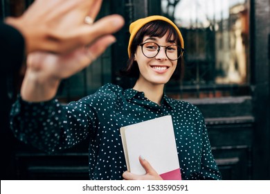 Stylish Young Female Student Giving High Five Outdoor, Celebrating Successful Examination At College. Happy Young Woman Giving Five To Friend During Friendly Collaboration On Studying Project