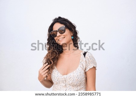 Similar – Woman with sunglasses looking at camera over garden fence