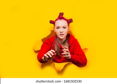 Stylish Young Girl Breaking Through Paper Wall