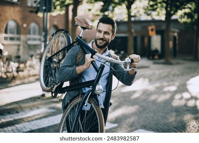 Stylish young man carrying bicycle on urban street - Powered by Shutterstock