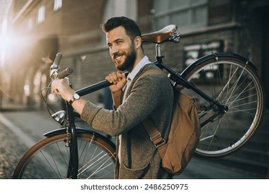 Stylish young man carrying bicycle on urban street - Powered by Shutterstock