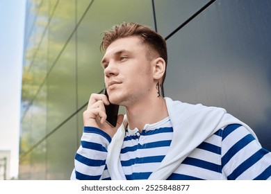 A stylish young man converses on his phone, showcasing his personality and prosthetic leg. - Powered by Shutterstock