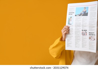 Stylish young man with newspaper on yellow background - Powered by Shutterstock