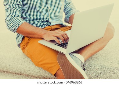 Stylish Young Man In A Shirt And Shorts, Sending Mail, Mounts, Video Editing And Photography,working Abroad,freelance Working,typing Online,social Networks,periscope,wi-fi 