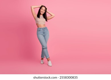 Stylish young woman in casual attire posing against a vibrant pink background with a joyful expression - Powered by Shutterstock