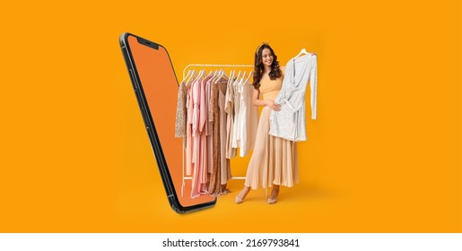 Stylish young woman with stylish clothes on hanger and modern mobile phone on yellow background - Shutterstock ID 2169793841
