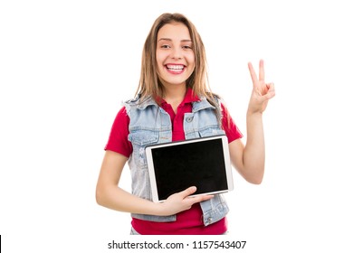 Stylish young woman showing two fingers while demonstrating modern tablet isolated on white background